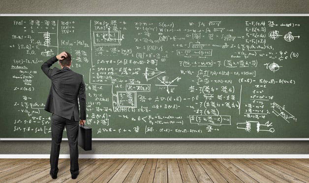 Foto: Mann steht vor Wandtafel mit vielen Formeln
